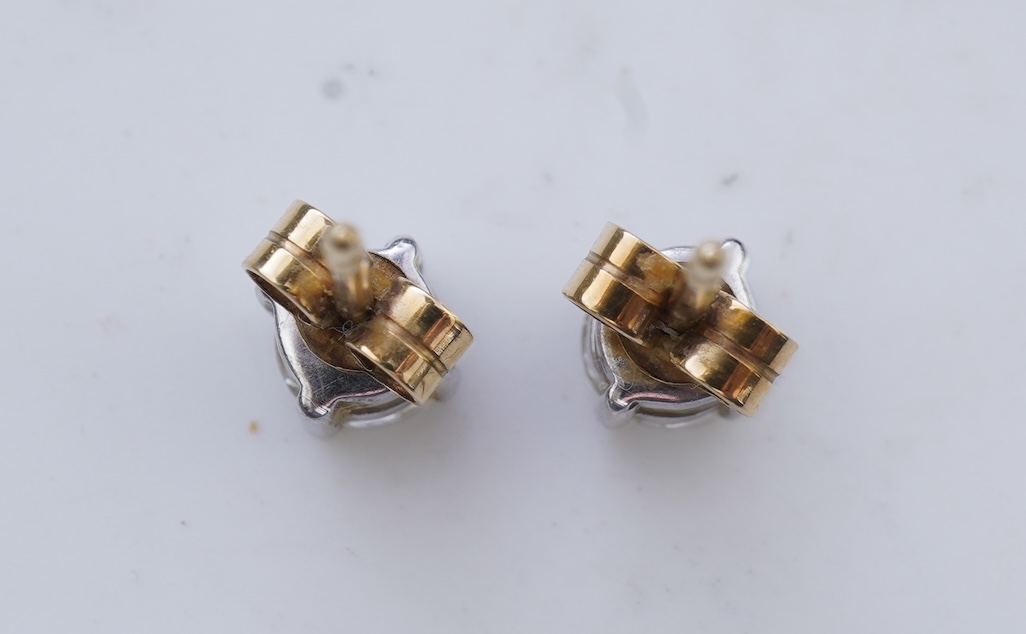 A pair of diamond stud earrings